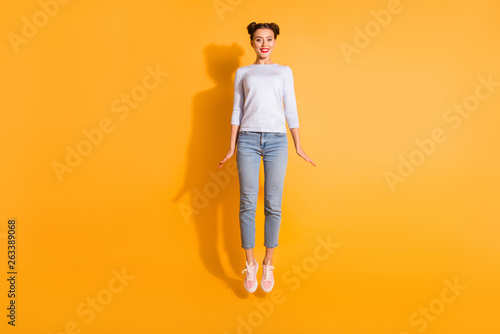 Full length body size photo of cute lovely funny girl having promenade outdoors dressed in white sweater blue denim clothes pink shoes isolated over bright background