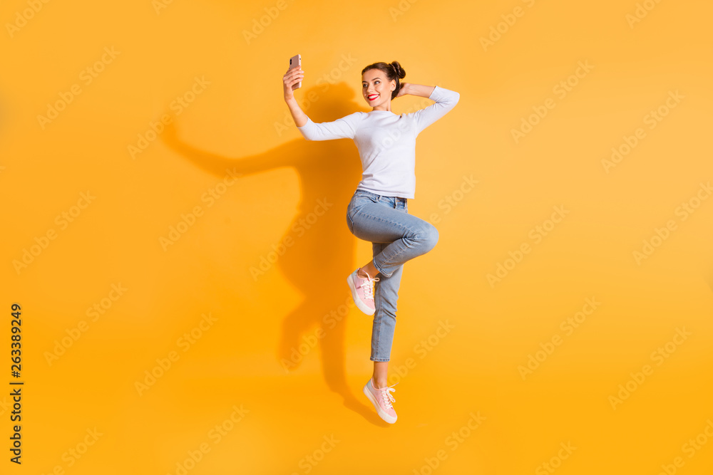 Full length body size photo of charming fashion lady student making photos video sharing posts internet social network wearing white denim pink clothing footwear isolated colorful background