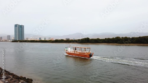 Boat passing by in Ras Al Khaimah creek in the northern emirate of the UAE photo