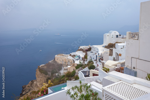 Panorama of houses in the village of Oia and the caldera on a rare rainy day