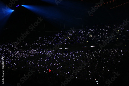 Crowd raising phones as lights