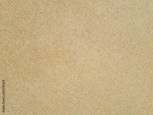 Top view of sandy beach. Background with copy space and visible sand texture. Detail of surface texture with small pebble rock on dirty ground and surface for background, Top view.
