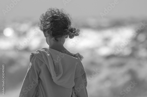 A young girl enjoying the wind and the view of the waves- Israel