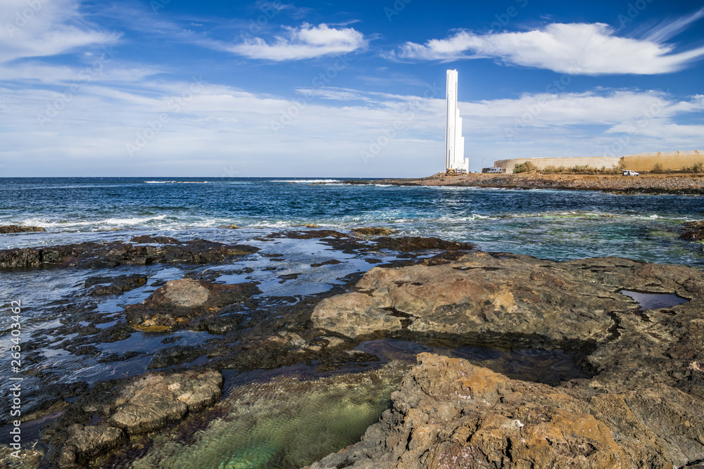 Rocky coast and white lighthouse