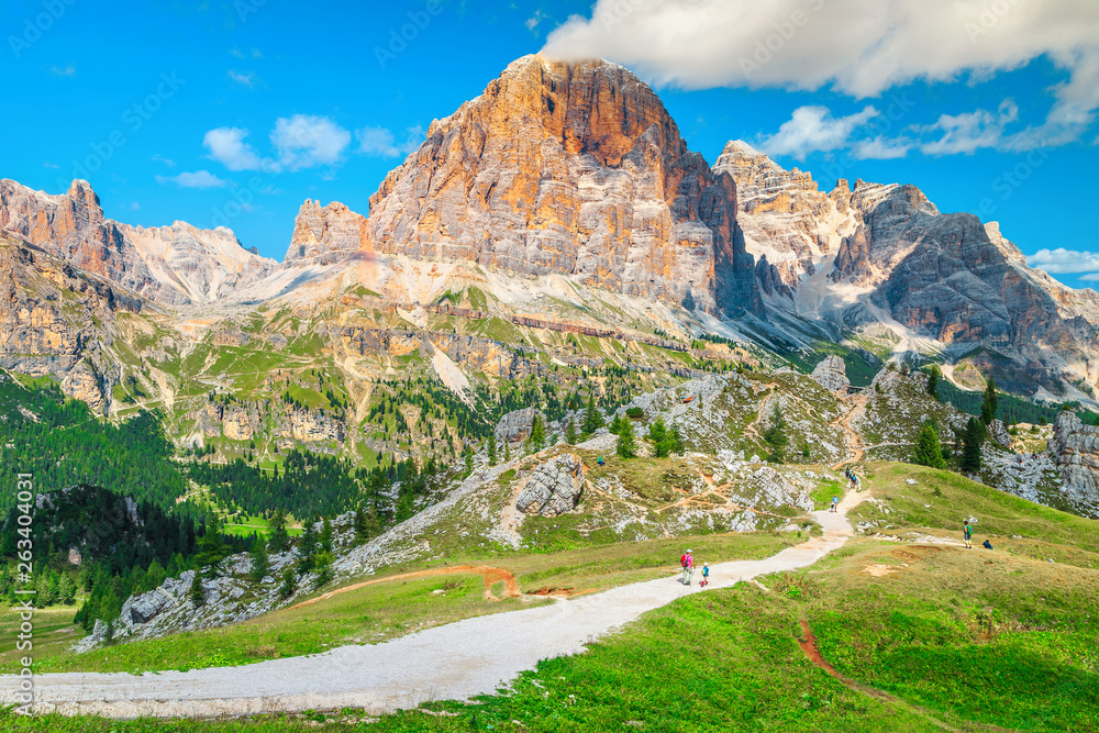 Hikers with backpacks walking on the mountain trails, Dolomites, Italy