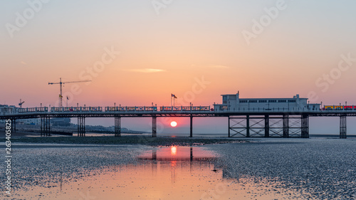 Dawn With Sun Rising Behind Worthing Pier at Low Tide