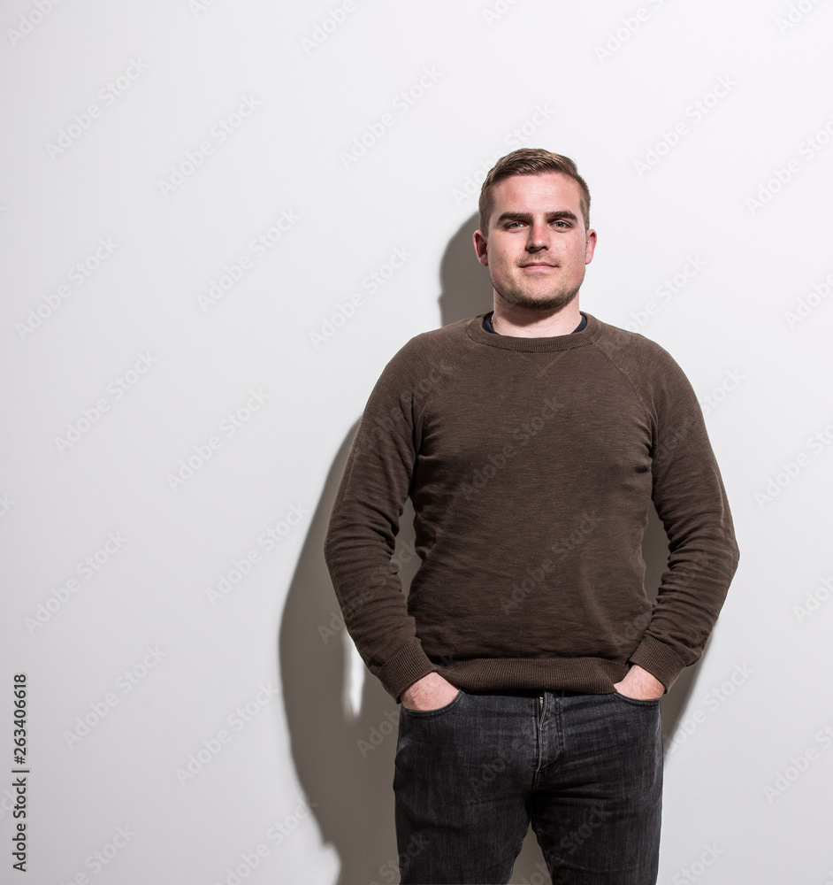 Fototapeta premium Real people portrait, handsome young man standing in front of white background
