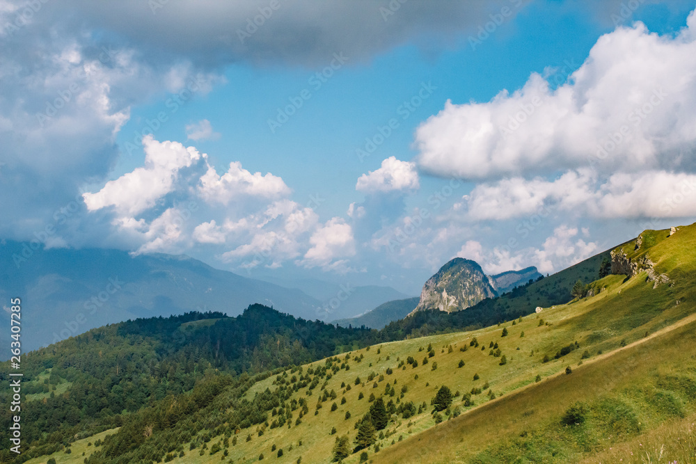 Naklejka premium Beautiful summer mountain landscape with clouds and a sunny day.