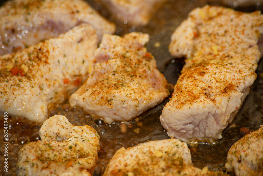 Yellow spices on turkey are steamed in the water