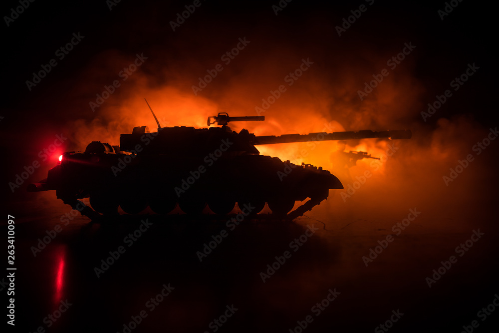 War Concept. Military silhouettes fighting scene on war fog sky background, World War German Tanks Silhouettes Below Cloudy Skyline At night. Attack scene. Armored vehicles. Tanks battle