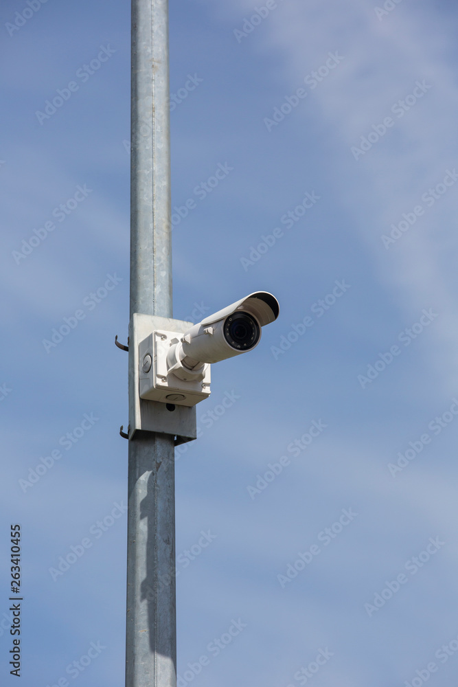 CCTV security cameras on pole on blue sky with white clouds background Limited depth of field. CCTV security cameras on pole on blue sky with white clouds background Limited depth of field.