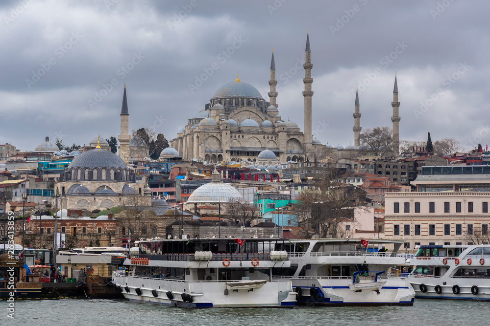 Naklejka premium Cityscape of Golden horn with ancient and modern buildings at Bosphorus strait in Istanbul Turkey with background of Suleymaniye mosque