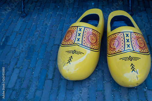yellow Dutch wooden shoes, clogs, on pavement