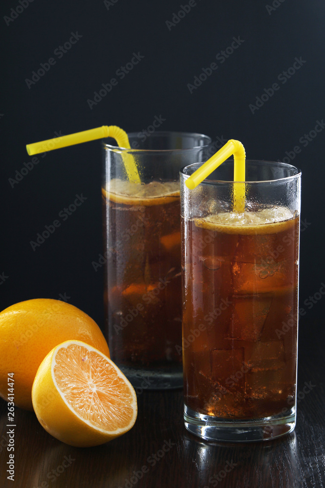 Glasses with cuba libre cocktail or cola with ice or cold tea with lemon Glasses with cuba libre cocktail or cola with ice or cold tea with lemon