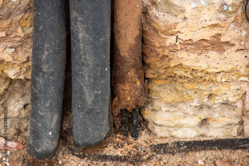Fototapeta premium Insulation made of rubber cable and rusty metal pipe