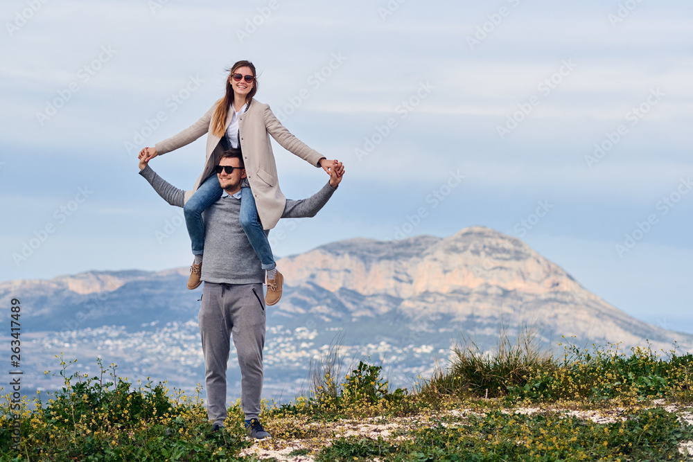 Young cute girl sitting on shoulders of her boyfriend Young cute girl sitting on shoulders of her boyfriend