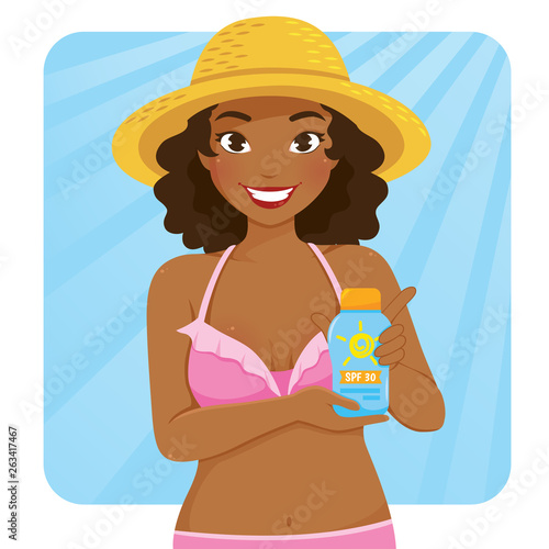 Beautiful dark skinned girl in swimsuit holding a bottle of sunscreen