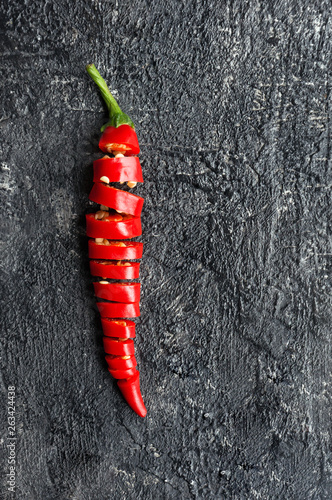 Sliced red hot chilli pepper. Top view. Vertical photo. 