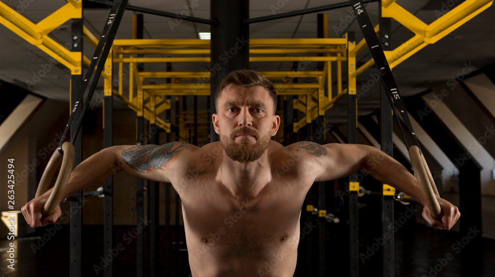 Man pulling up on a gymnastic rings Man pulling up on a gymnastic rings