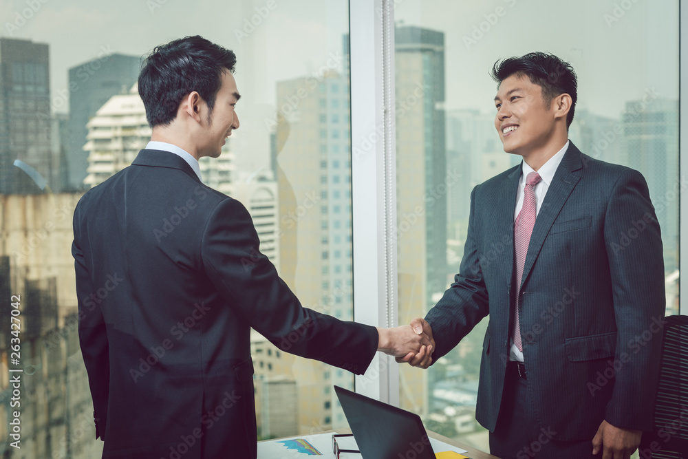 Businessman shaking hand with his partner Businessman shaking hand with his partner