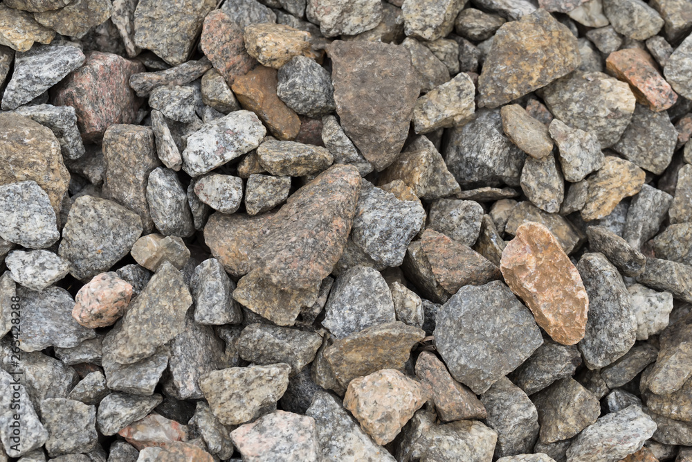 Multi-colored stones on the ground. Different shapes and sizes Multi-colored stones on the ground. Different shapes and sizes