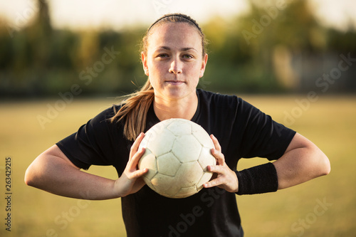 Young woman soccer player holding soccer ball © bokan