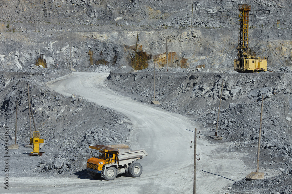 Quarry drilling machine and large truck in the quarry. Quarry drilling machine and large truck in the quarry.
