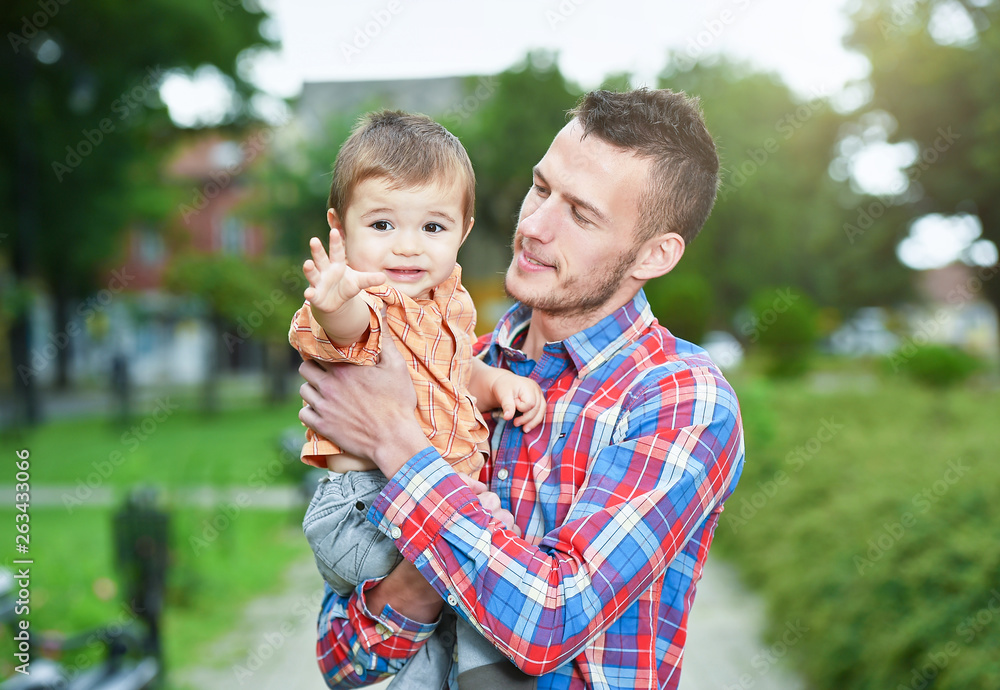 Fototapeta premium father holds son in a park