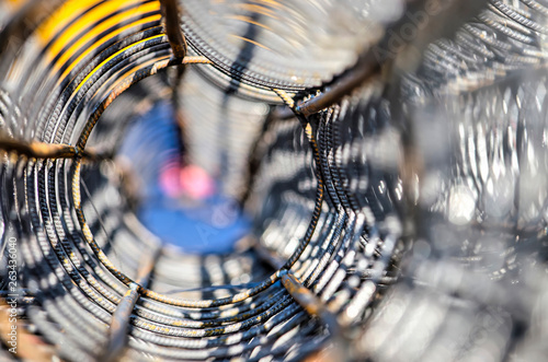 View with selective focus through a tubular reinforcement net to be placed in a concrete column, on a sunny day on a building site photo