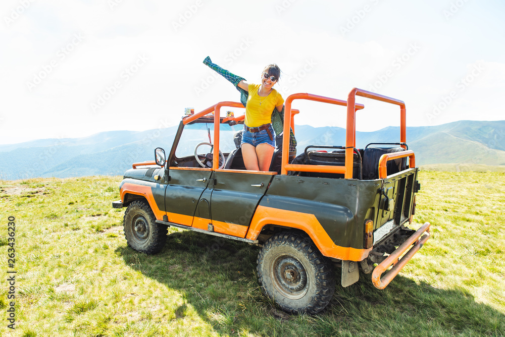 happy laughing woman on suv car in mountains happy laughing woman on suv car in mountains