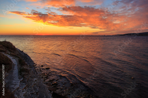 Beautiful red sunset in the Black sea near the resort of Gelendzhik. Red clouds over the steep Bank. Beauty.