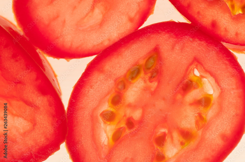 Sliced red tomato on a white background. Macro. Pattern. Food background. Sliced red tomato on a white background. Macro. Pattern. Food background.