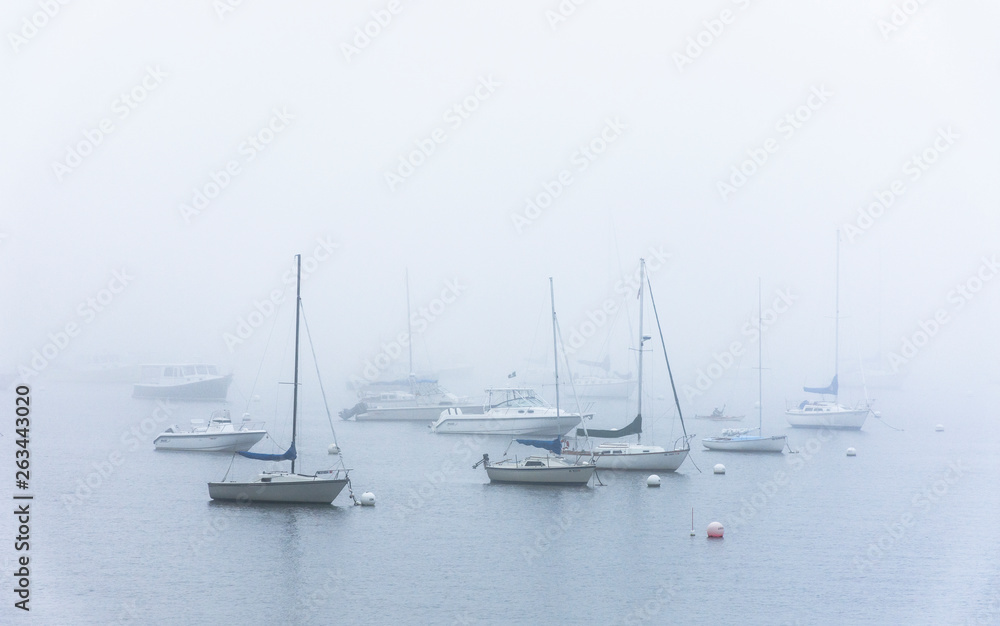 boats at anchor in fog