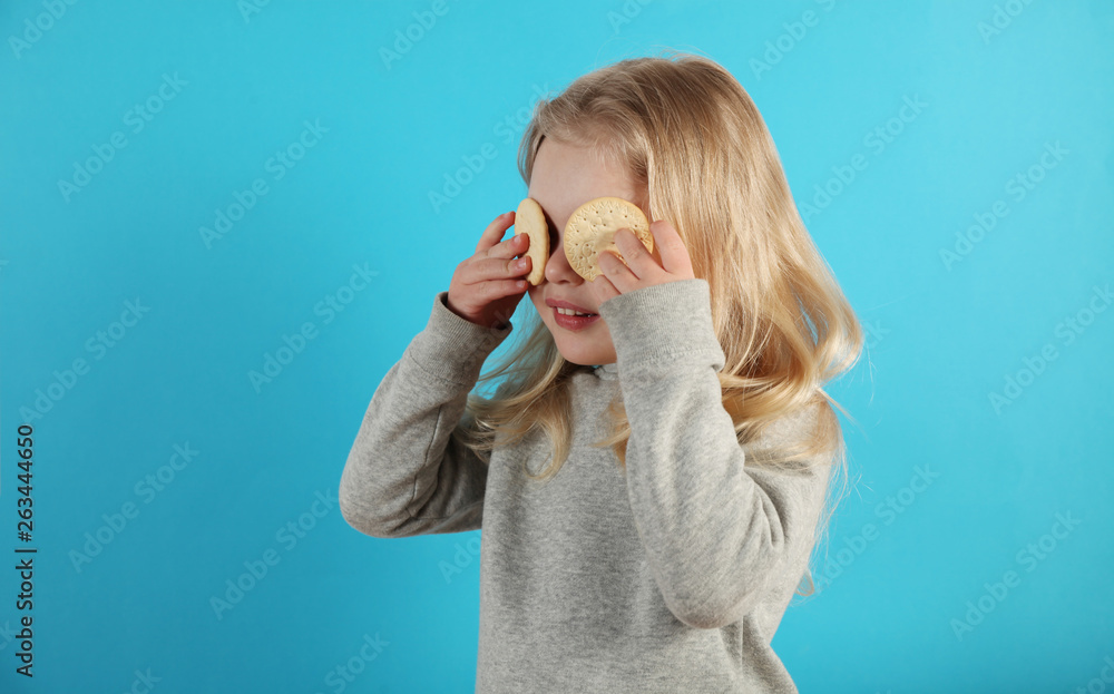 Small cute girl playing with cookies and eating it. Small cute girl playing with cookies and eating it.