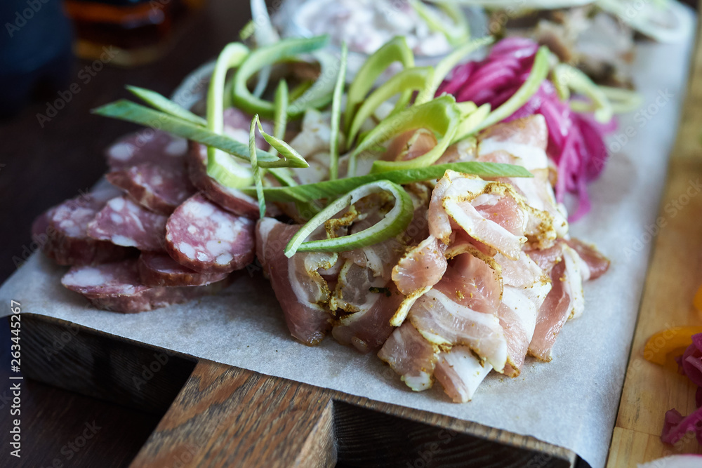 Sliced vegetables and meat with sauce. Selective focus.