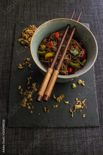 Veggie yakisoba in bowl with fried onion. photo