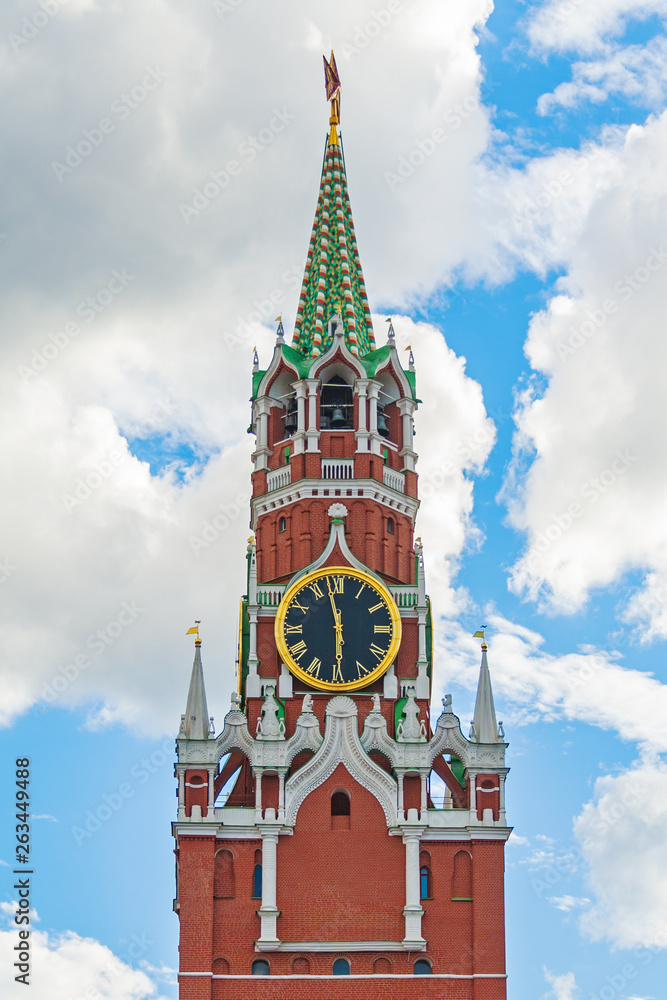 Front view on the Spasskaya Tower of the Moscow Kremlin (Russia) against a blue sky with clouds