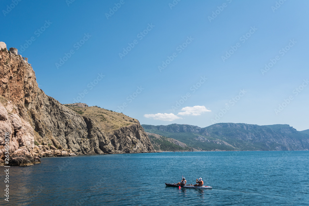 Sea Kayaking in calm waters. Beautiful seascape. Adventure couple. 