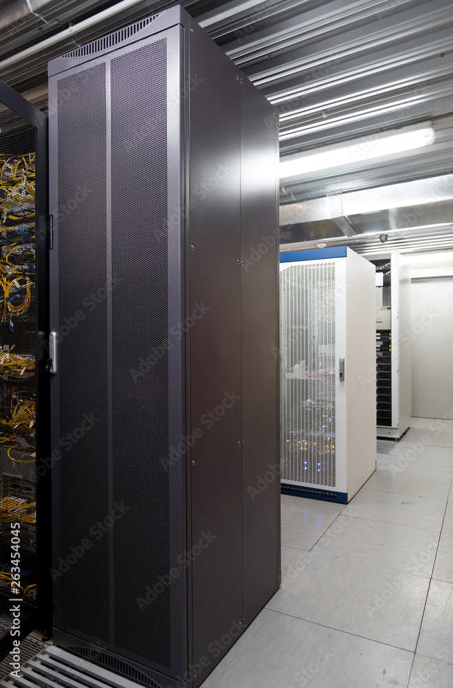 Grey and white server cases in datacenter modern server room