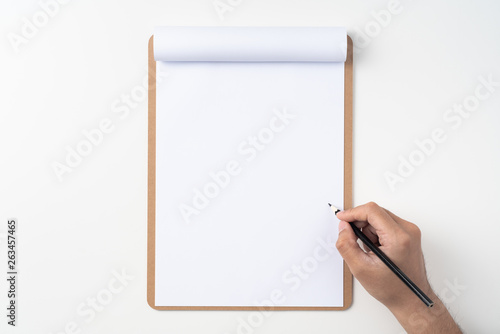 white paper on clipboard with mans hand