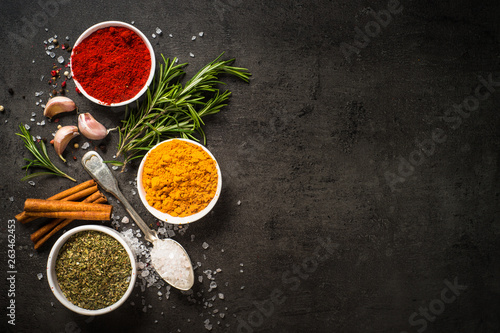 Fototapeta Naklejka Na Ścianę i Meble -  Set of various spices on black background.