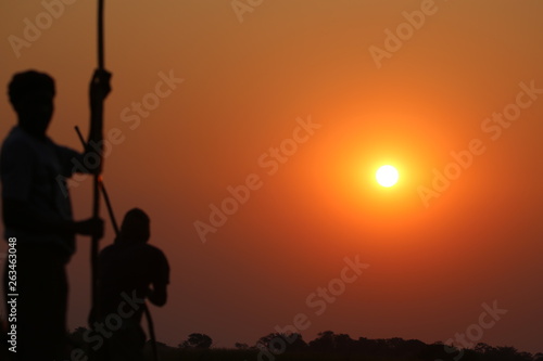 silhouette of climber on top of mountain