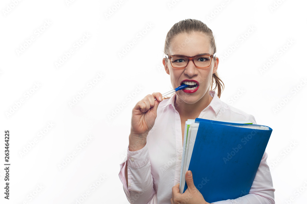 Young woman in eyeglasses with folder bites pen Young woman in eyeglasses with folder bites pen