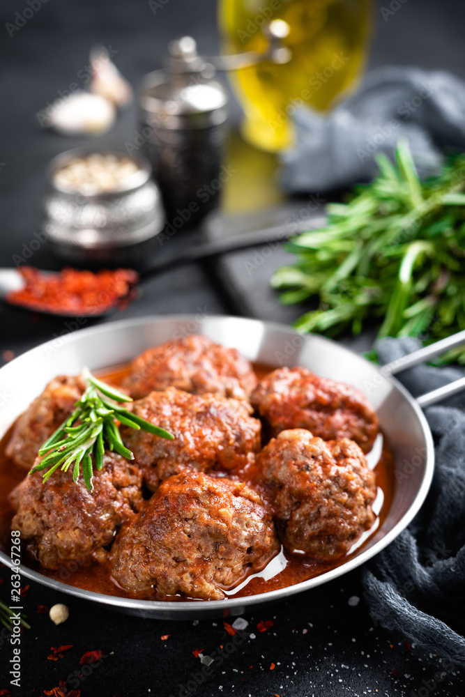 Beef meatballs with spices in tomato sauce