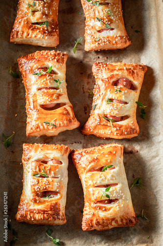 Homemade sausage in puff pastry with thyme and sesame seeds