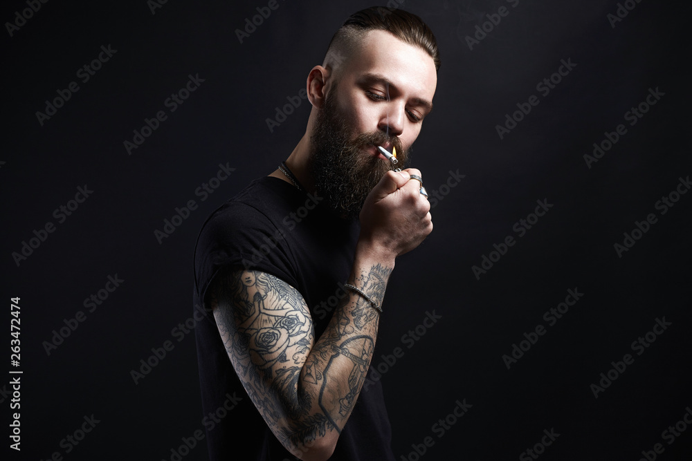 smoking man. Hipster tattoed boy with cigarette