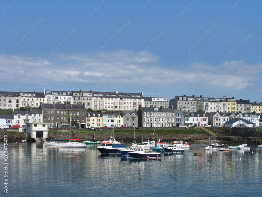 Houses and boats in the harbour by the irish sea Co. Antrim Northern Ireland 2017 with  blue sky background for editors text copy