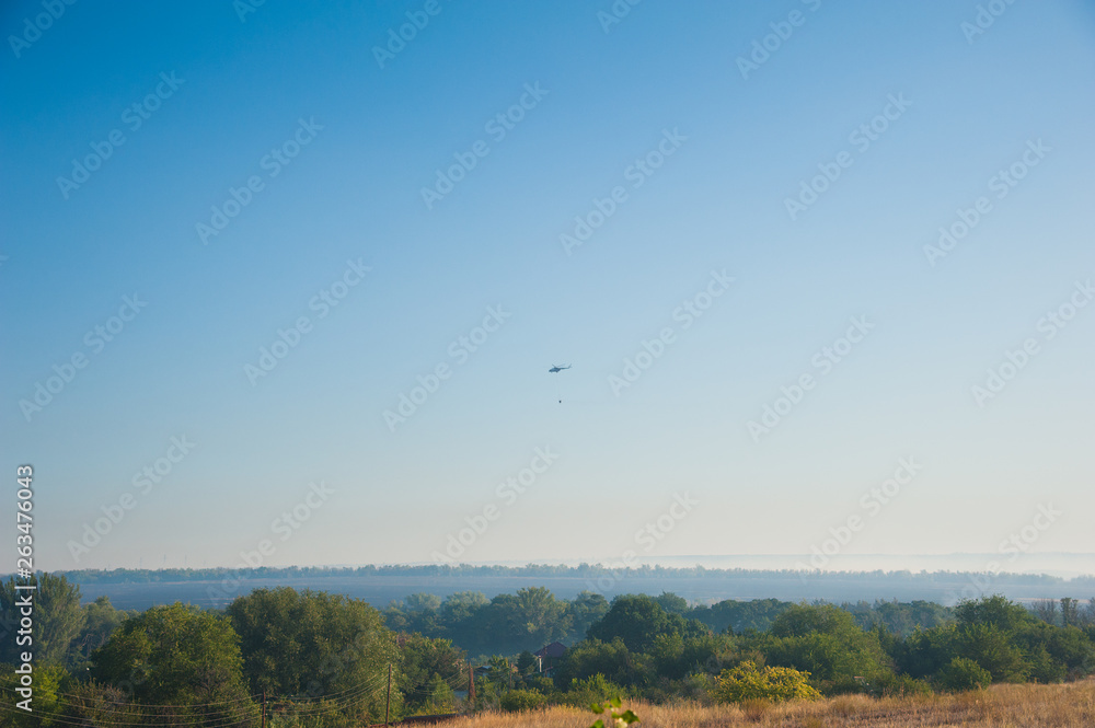 Fire helicopter extinguishes a forest fire Fire helicopter extinguishes a forest fire