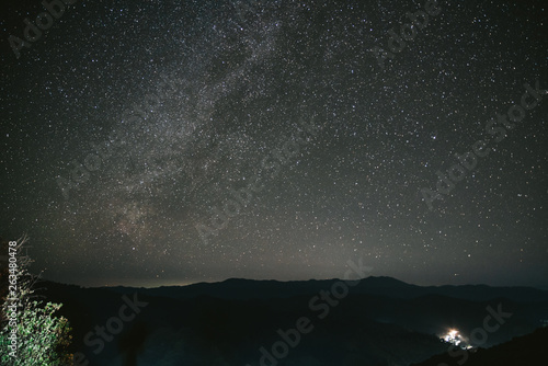 Night sky with bright stars in the Akha village of Maejantai on the hill in Chiang Mai, Thailand.