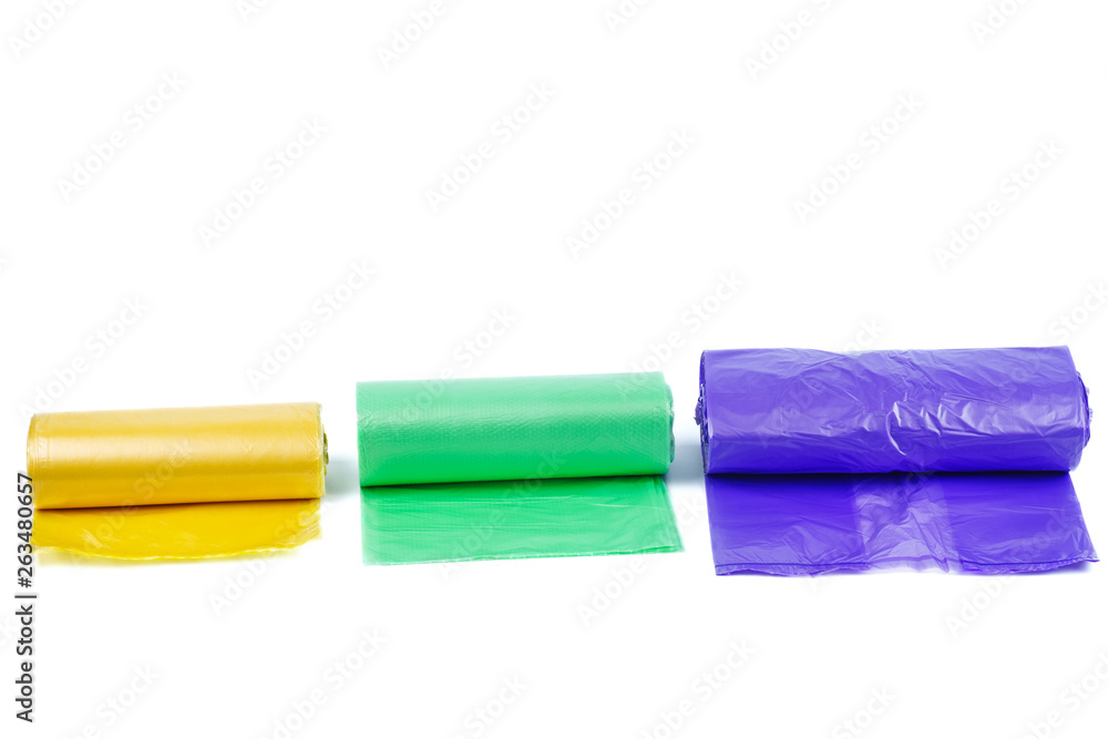 Rolls of yellow, green and purple plastic garbage bags Rolls of yellow, green and purple plastic garbage bags